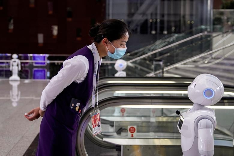 A staff member looks at a robot at the venue for the World Artificial Intelligence Conference (WAIC) in Shanghai, China. REUTERS/Aly Song  